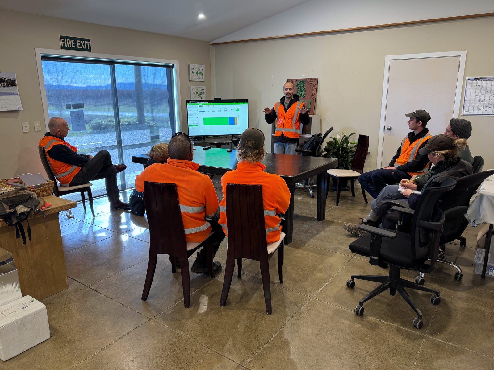 A Cropsy team member presenting Osiris on a screen to vineyard staff seated in a meeting room